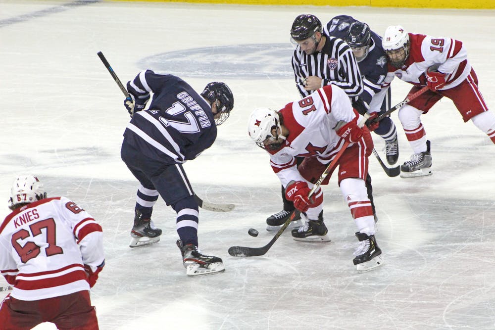 Sophomore forward Monte Graham battles for the puck during a 4-4 tie against New Hampshire on Oct. 12 at the Goggin Ice Center.