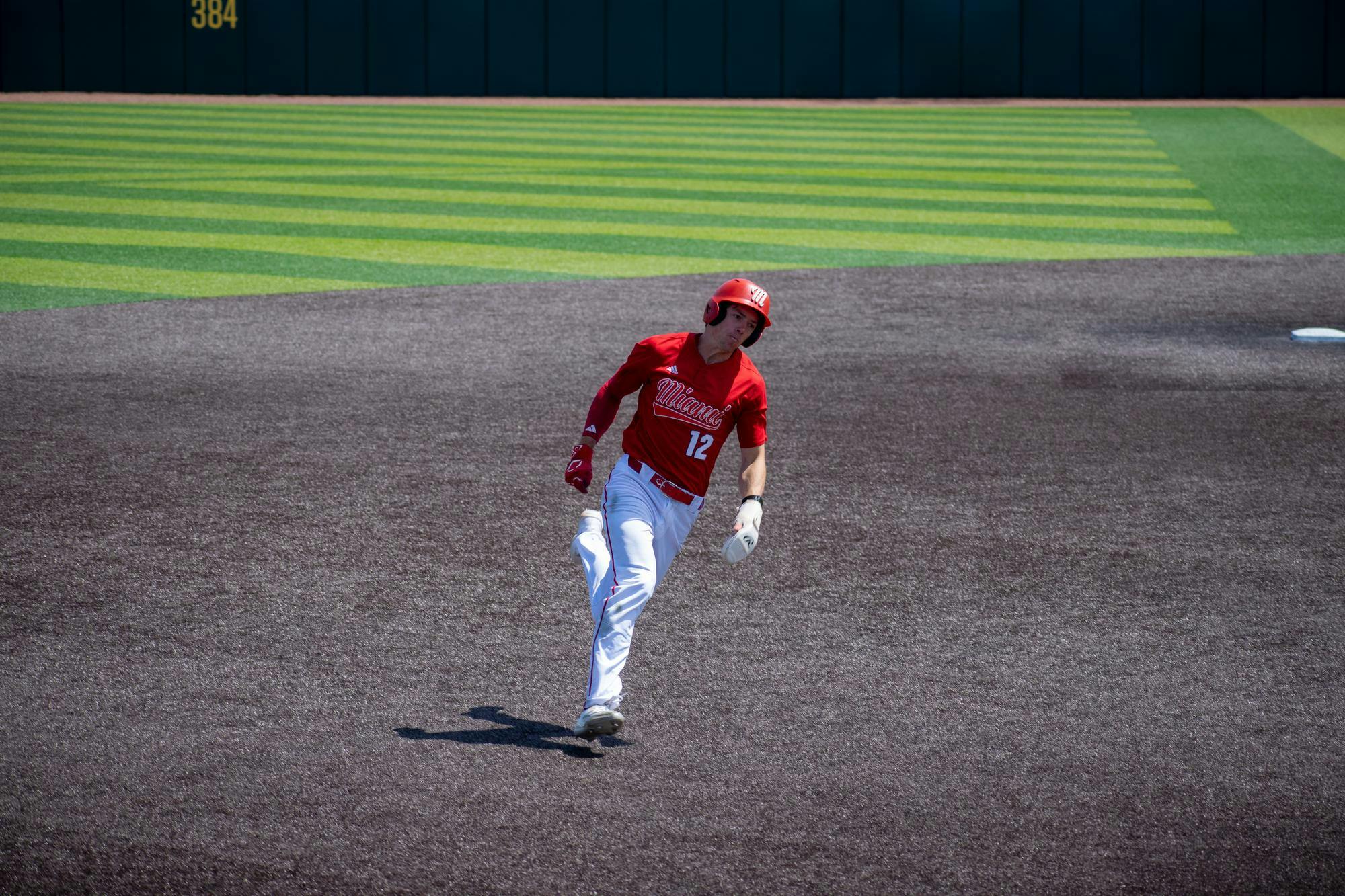 Junior outfielder Marcus Dierks runs into third during game against Ohio University.