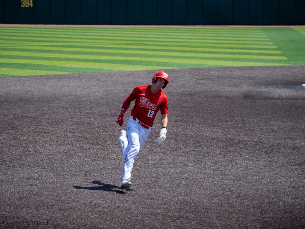 Junior outfielder Marcus Dierks runs into third during game against Ohio University.