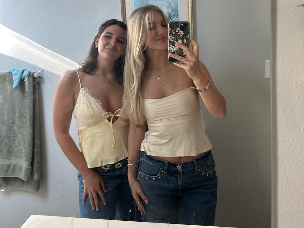 Olivia Michelsen (left) and Madeline Buecker (right) smile for a photo together. Photo provided by Olivia Michelsen