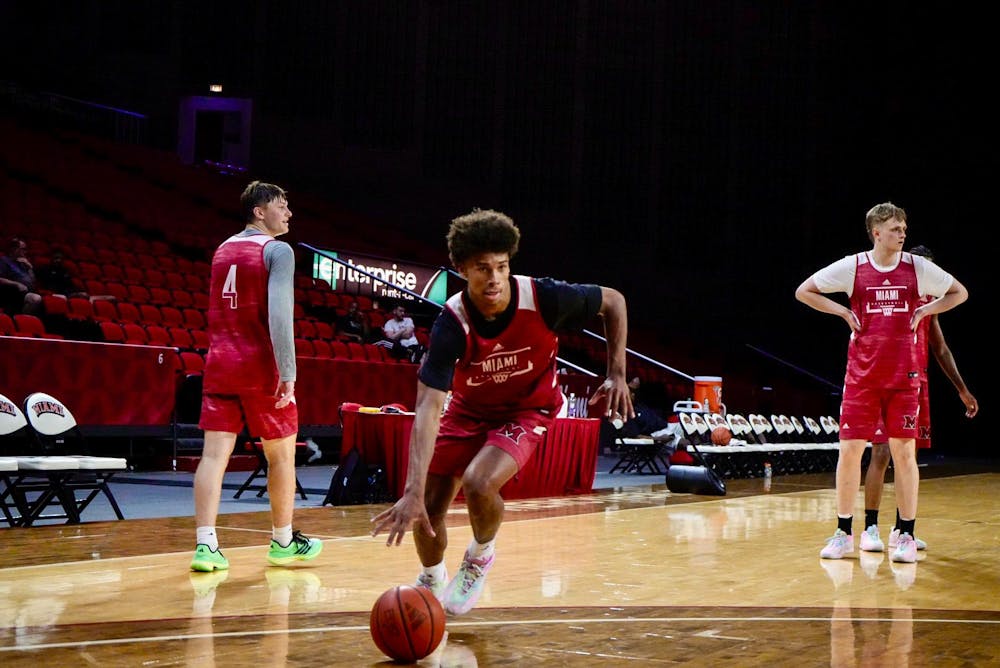 <p>First-year guard Justin Kirby dribbles towards the basket at Millett Hall during a summer practice.</p>