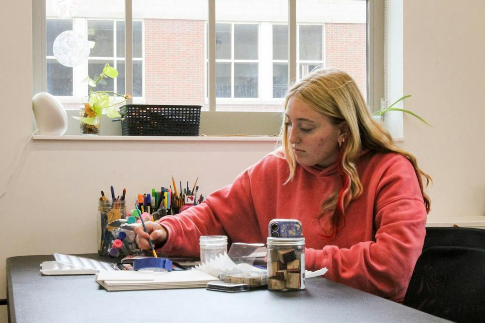 A student paints in the Wellness Studio on the second floor of the Clinical Health Sciences and Wellness Facility.