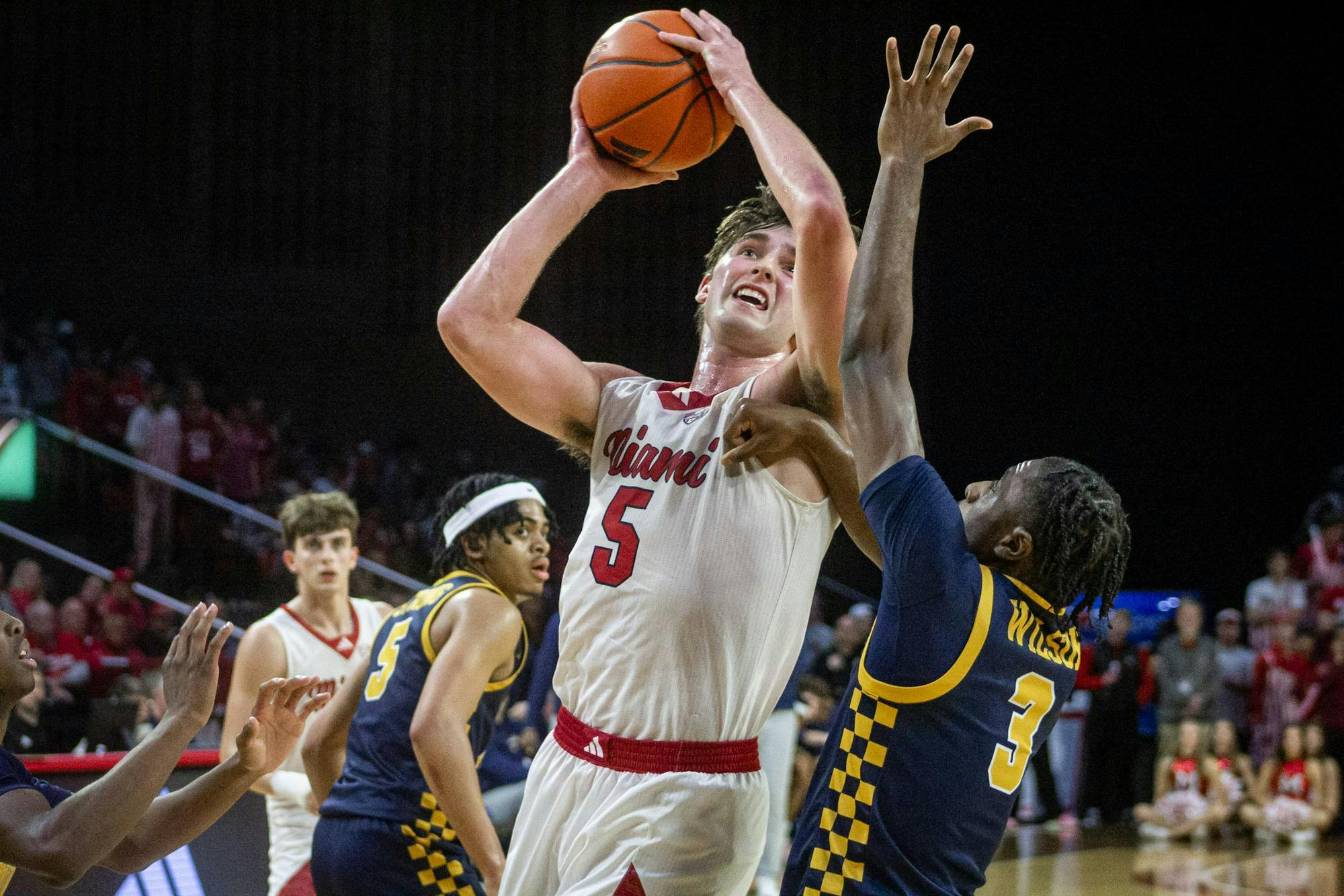 Senior guard Peter Suder shoots a contested shot over junior guard Sonny Wilson against the Toledo University Rockets on March 3.