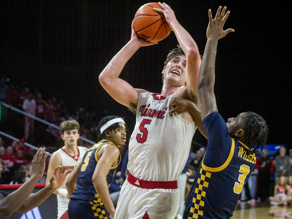 Senior guard Peter Suder shoots a contested shot over junior guard Sonny Wilson against the Toledo University Rockets on March 3.