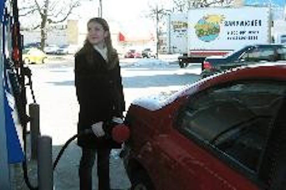 First-year Amy Schumacher fills her gas tank at United Dairy farms in Oxford. Some filling stations in the Cincinnati area have also begun offering ethanol. 
