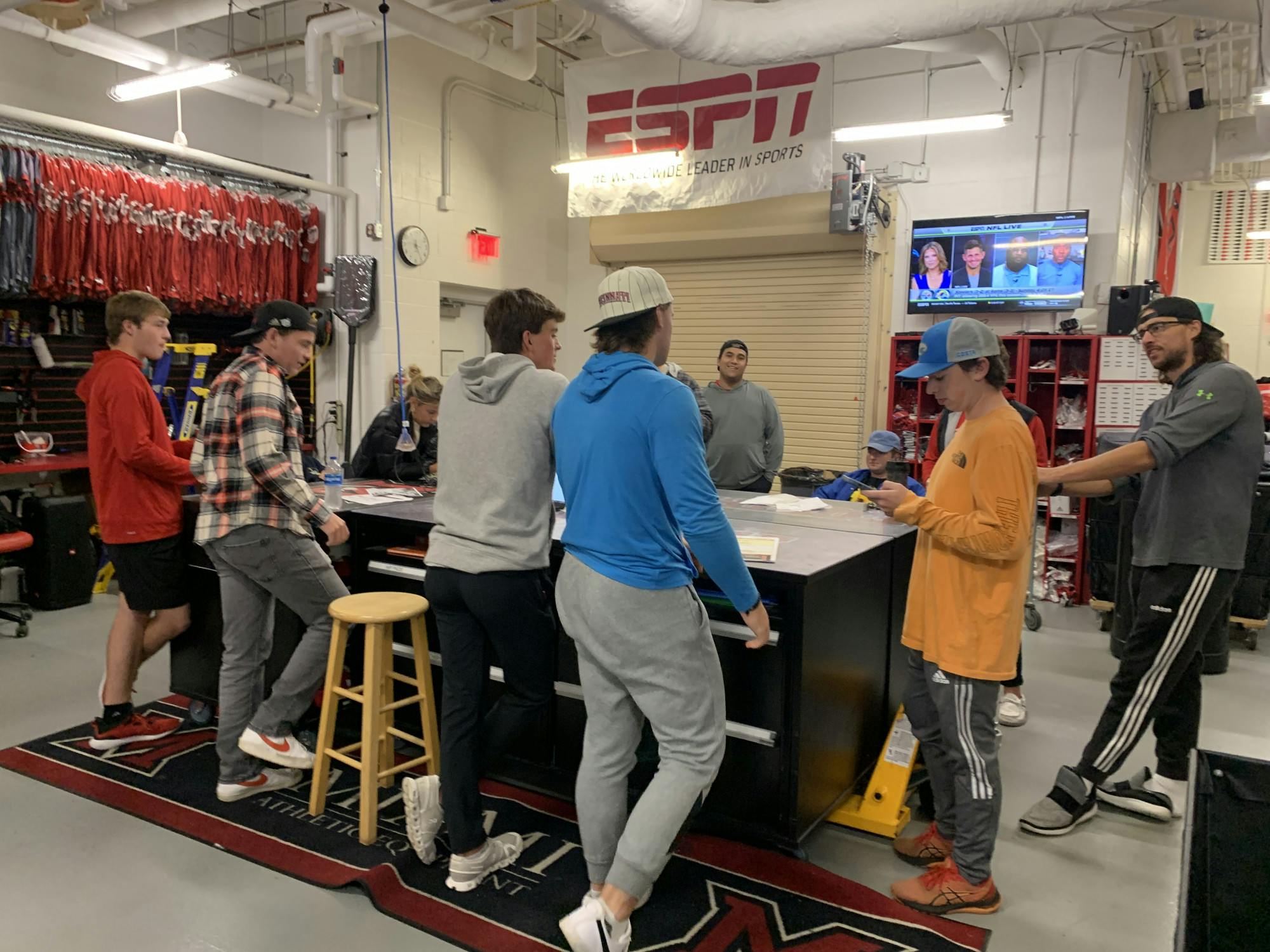 Miami football equipment coordinator Adam Boyer addresses his student team before a mad dash to set up the locker room for Miami’s game against Toledo. Photo by Jack Schmelzinger