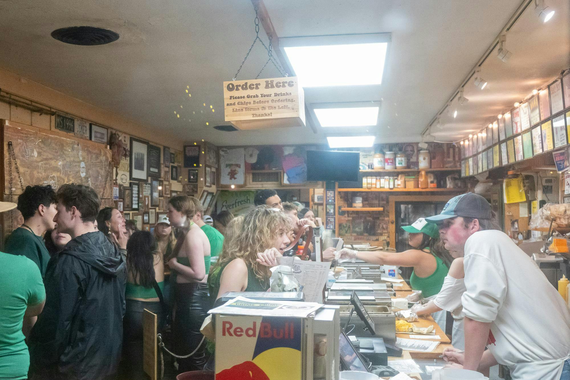 Customers stand in line at Bagel &amp; Deli.
