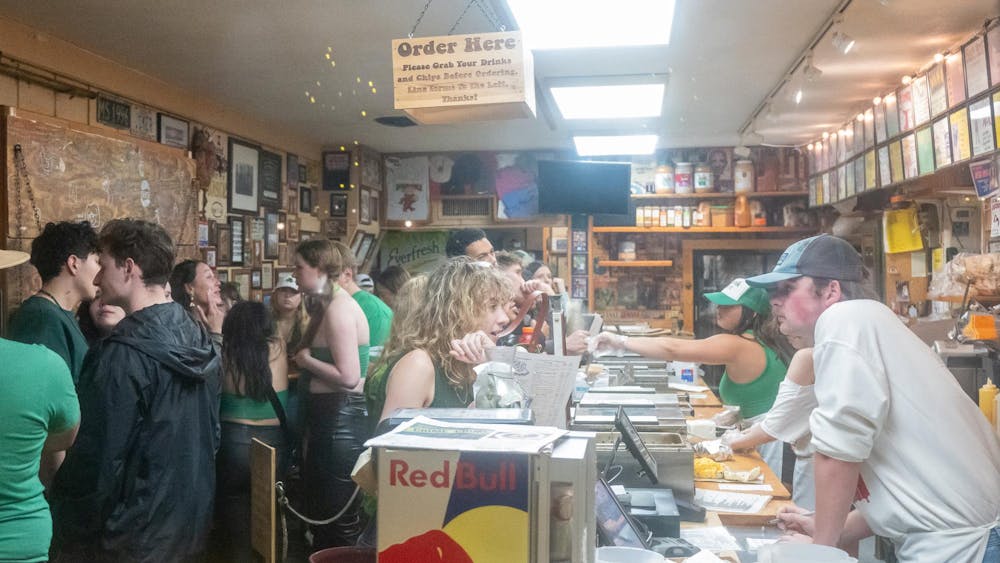 Customers stand in line at Bagel & Deli.
