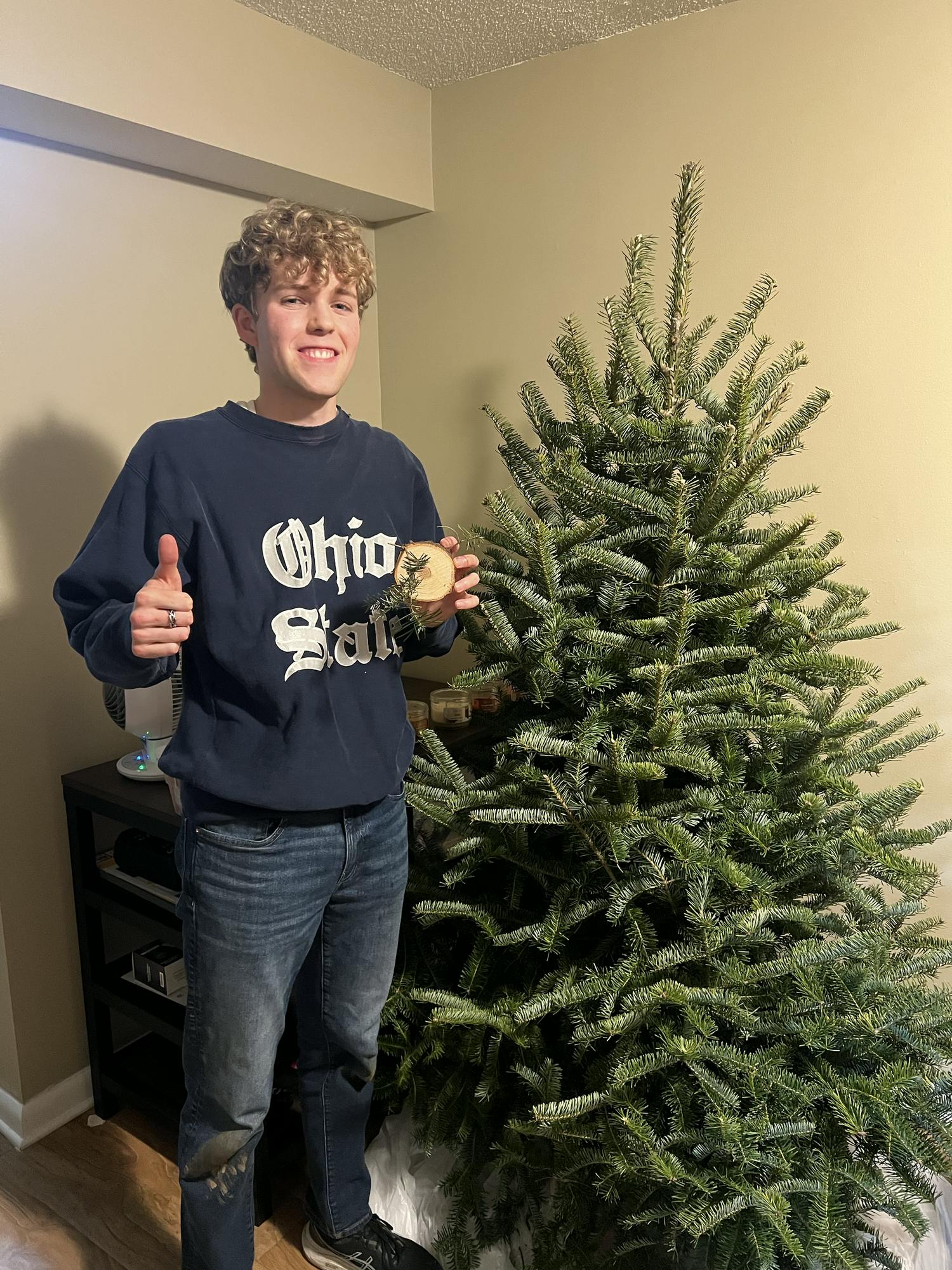 Jacob Van Riper stands with the tree he cut down at John T. Nieman Nursery, a Christmas tree farm in Hamilton. Photo provided by Jacob Van Riper.