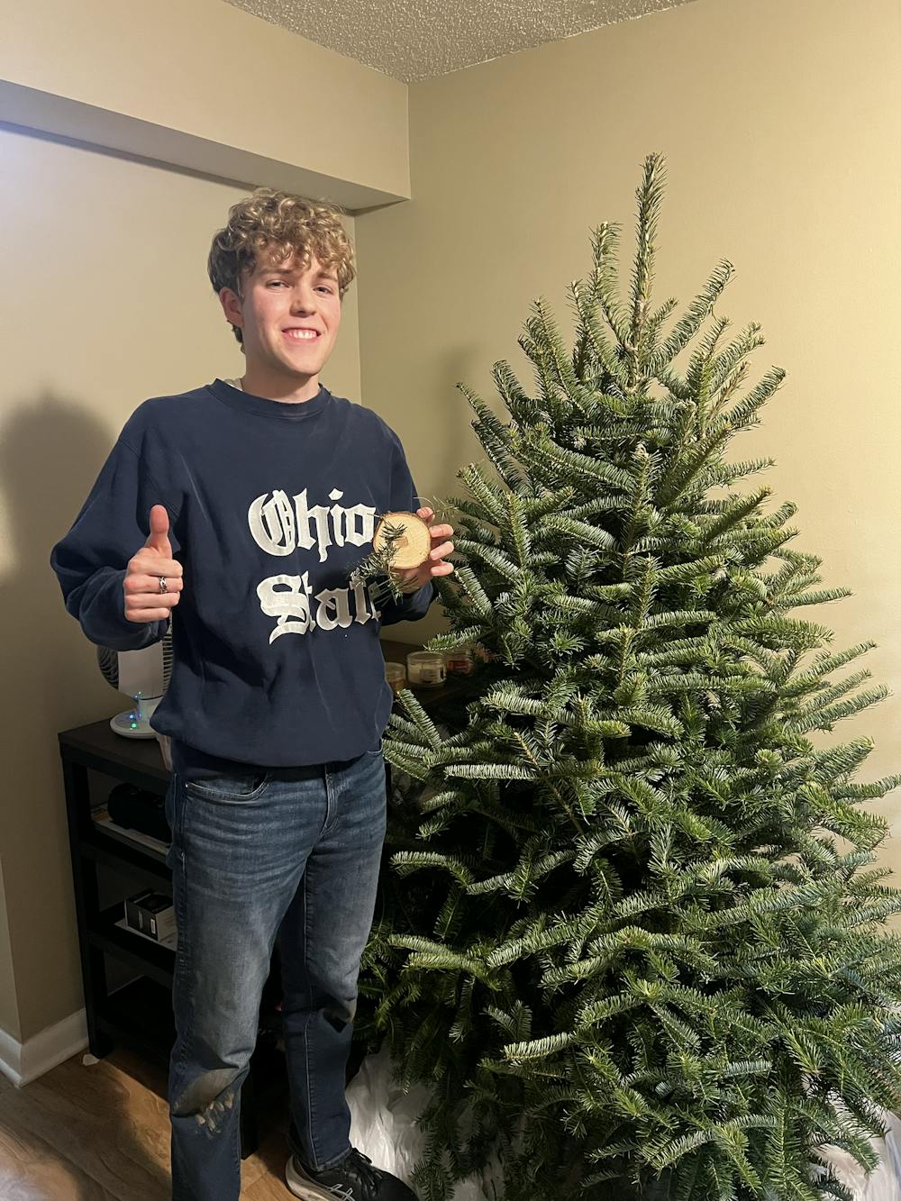 Jacob Van Riper stands with the tree he cut down at John T. Nieman Nursery, a Christmas tree farm in Hamilton. Photo provided by Jacob Van Riper.