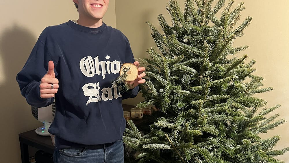 Jacob Van Riper stands with the tree he cut down at John T. Nieman Nursery, a Christmas tree farm in Hamilton. Photo provided by Jacob Van Riper.