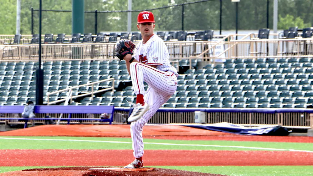 Graduate student Clayton Burke kicks to deal a pitch against Kent State on May 22