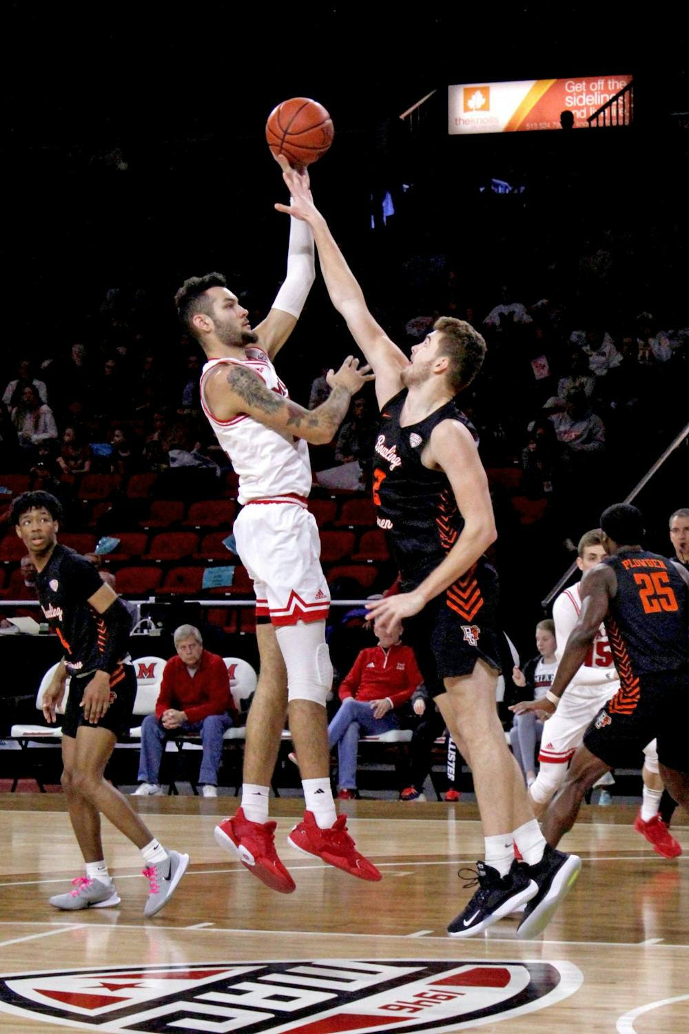 Miami sophomore forward Eli McNamara attempts a hook shot over a Bowling Green defender during a 73-55 RedHawk victory over the Falcons on Feb. 29 at Millett Hall.