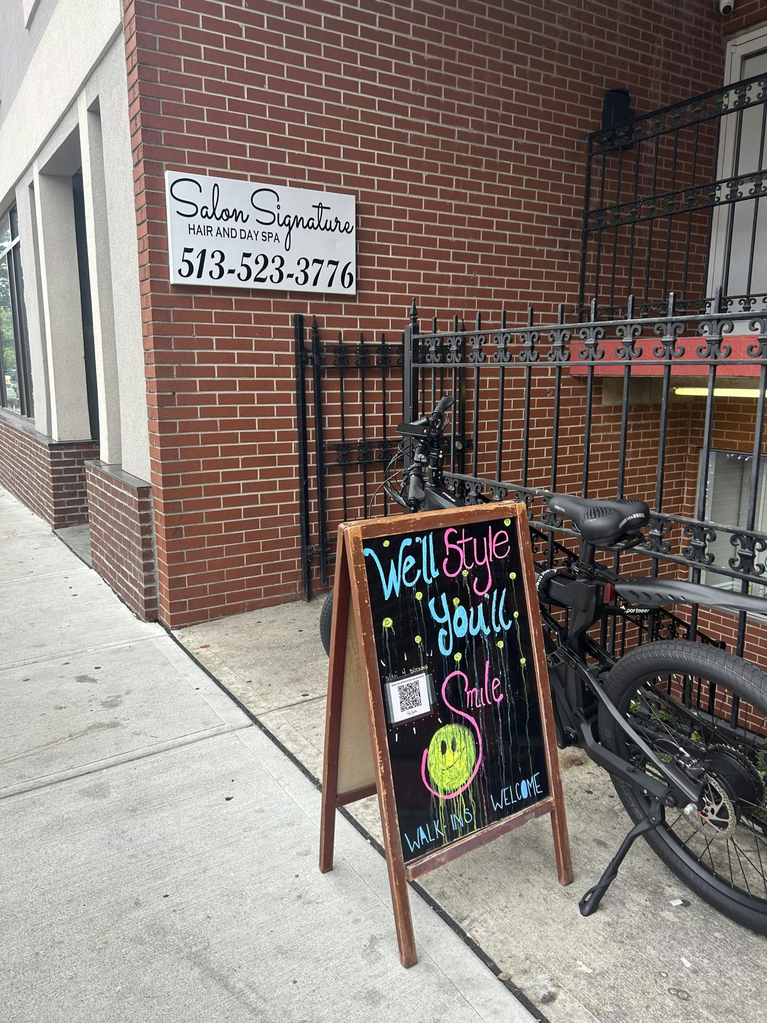 Salon Signature draws customers in with its chalkboard sign.
