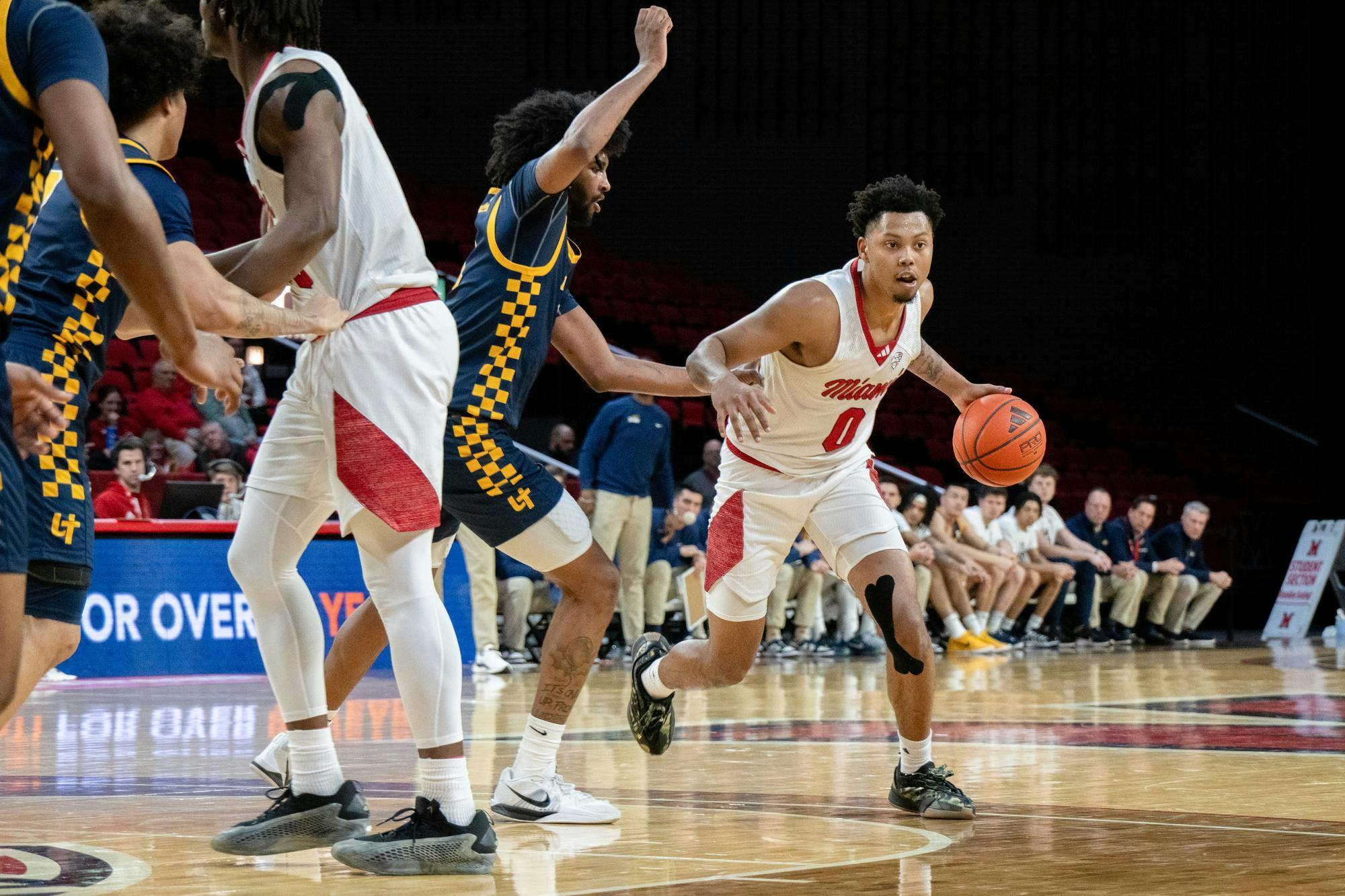 Eian Elmer dribbles toward the rim at Millett last season against Toledo.