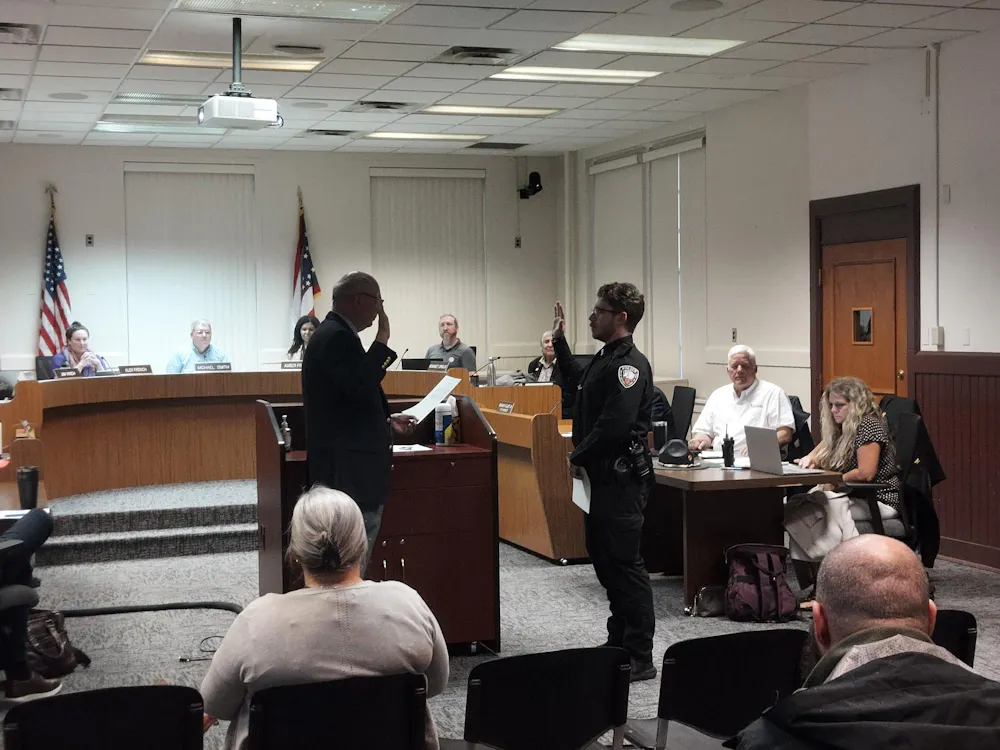 Law Director Christopher Conard gives oath to new Oxford police officer Jack Halbeisen