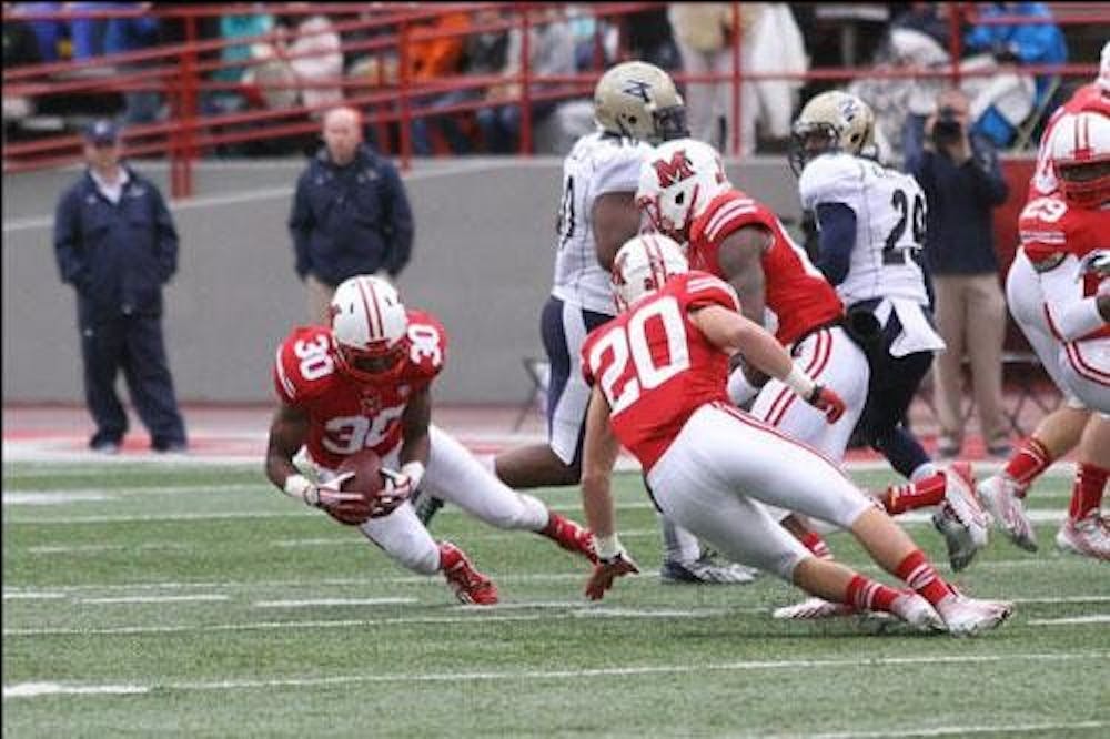 Miami freshman saftey Buchi Okafor recovers a fumbled punt during Miami’s 24-17 loss Akron. 