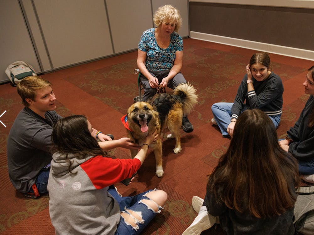 Dog therapy relieves the stress of students and maybe also the dogs, like this one named Luke Skywalker, who gets to enjoy pets.