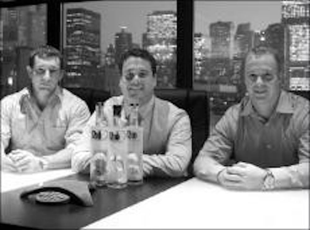 Miami University graduates Phil Walker, Myron Powelson and Ryan Schuman, from the class of 2005, pose in front of their Rio D cachaça in their Chicago office. 