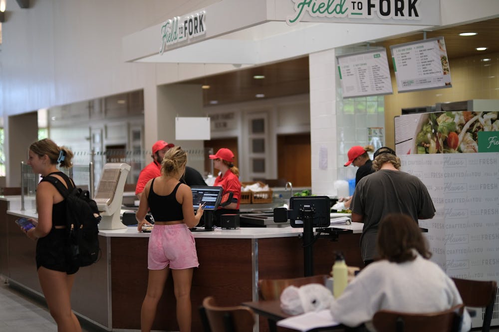 Students finish placing their orders at Field to Fork, Armstrong Student Center's newest salad bar.