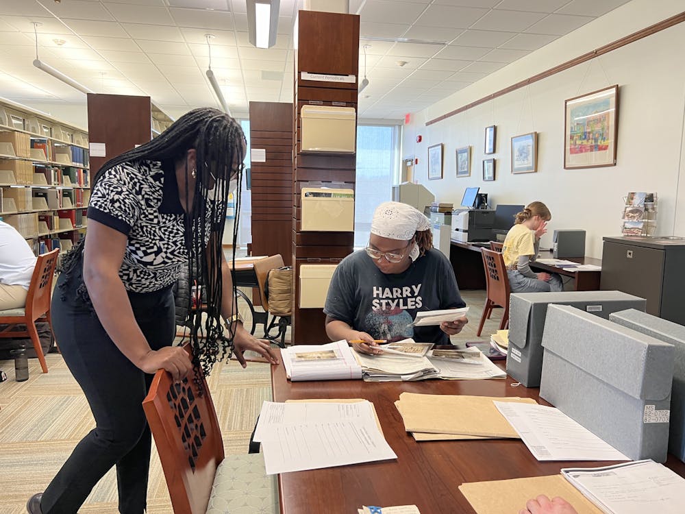 Jazma Sutton (left) helps graduate student Tyayia Young review documents during class in the Smith Library of Regional History.