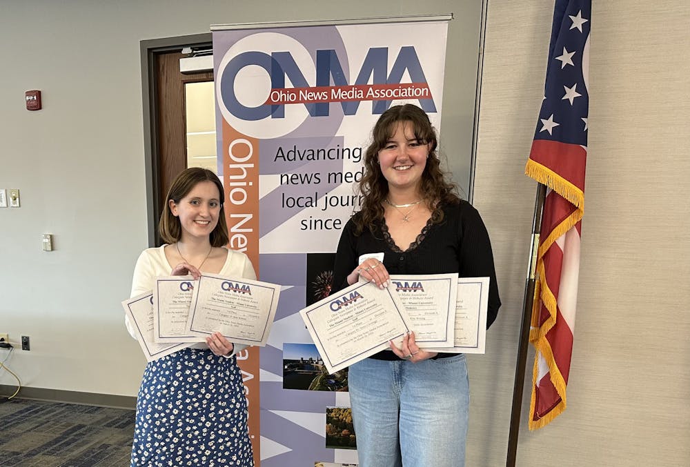 Shannon Mahoney and Taylor Powers accept awards on behalf of The Miami Student