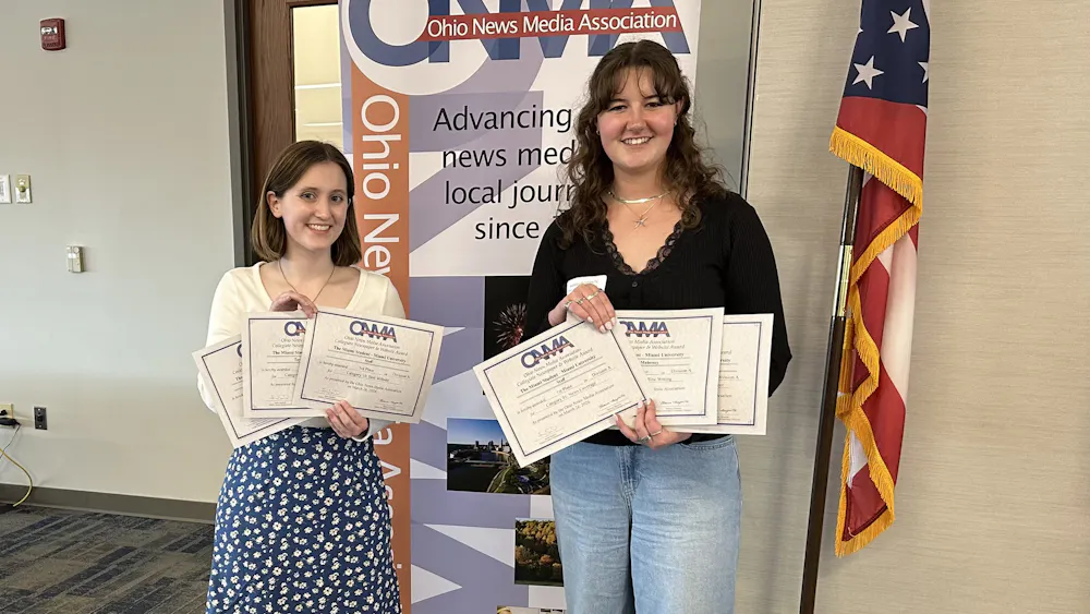 Shannon Mahoney and Taylor Powers accept awards on behalf of The Miami Student