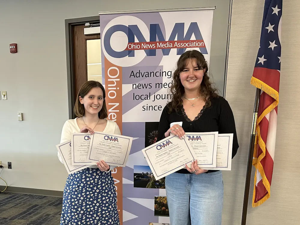 Shannon Mahoney and Taylor Powers accept awards on behalf of The Miami Student