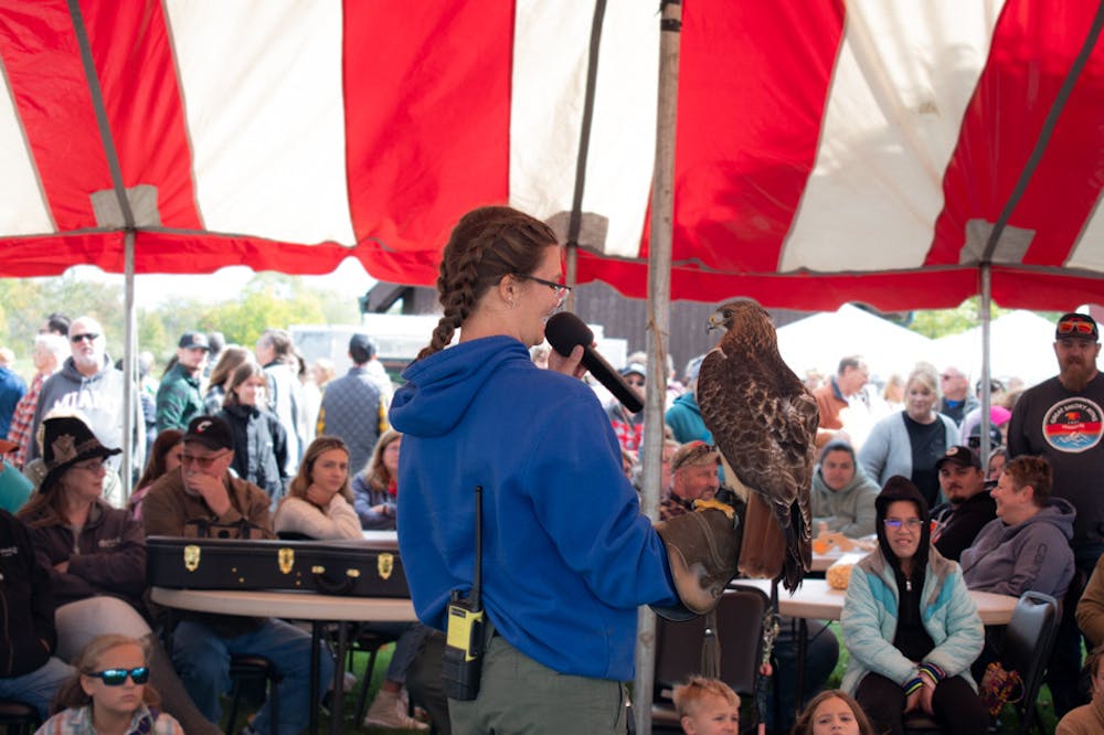 A falconer shows the bird to onlookers. 