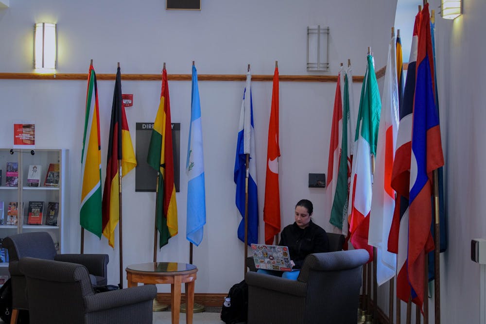 Miami University student studying in the MacMillan Hall lobby.