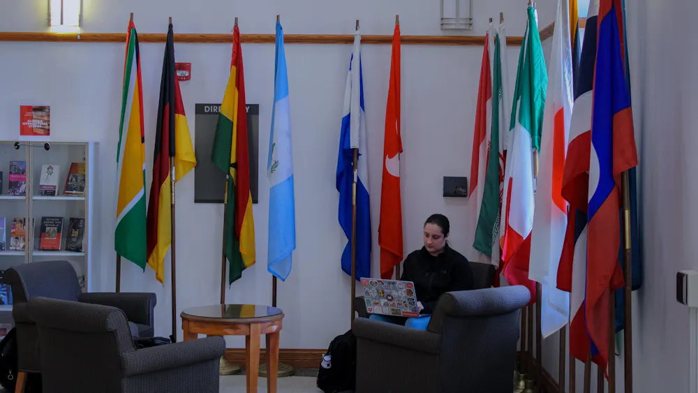 Miami University student studying in the MacMillan Hall lobby.
