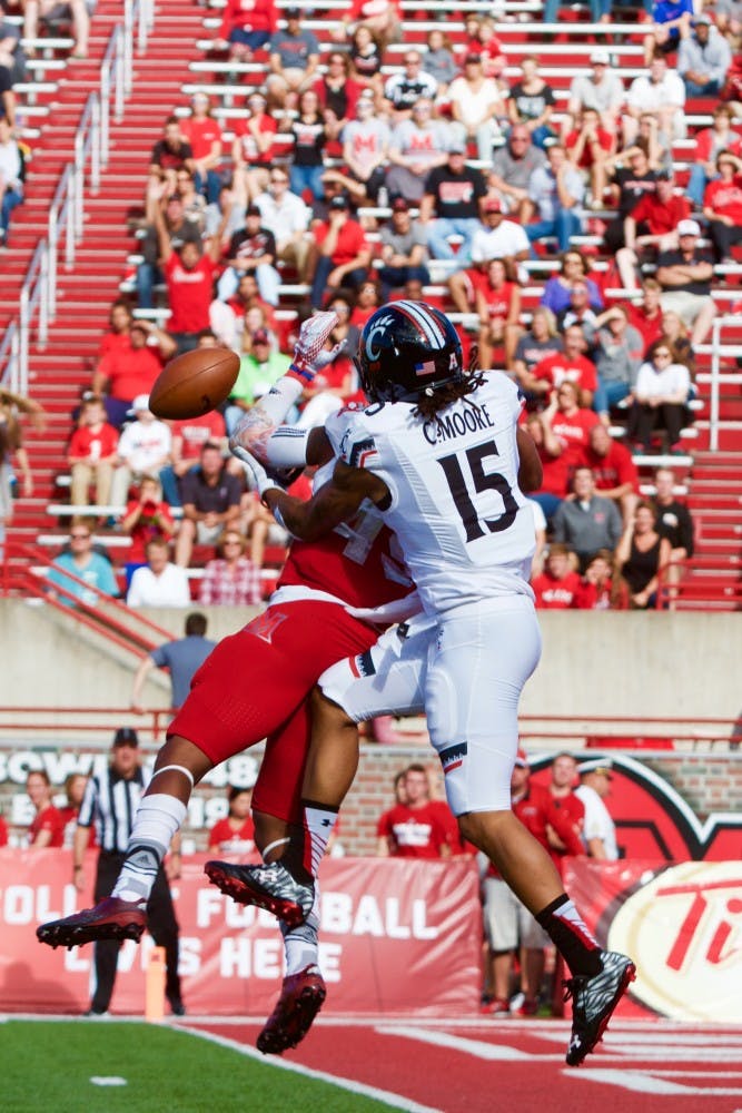 Junior linebacker TJ Williams breaks up a pass intended for UC senior receiver Chris Moore. Williams led MU's defense with 12 tackles.