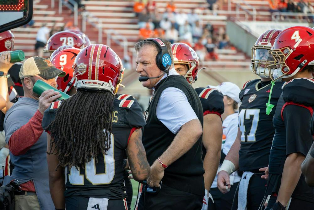 Head coach Chuck Martin talks to his team during game against Bowling Green State University. 