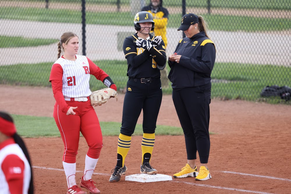 As the pitching coach for the Hawkeyes, Gardner-Colegate (far right) dropped the team’s ERA from 5.03 to 2.57 in one year.