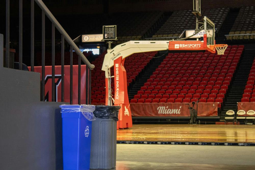 Trash cans sit court side at Millet Hall.