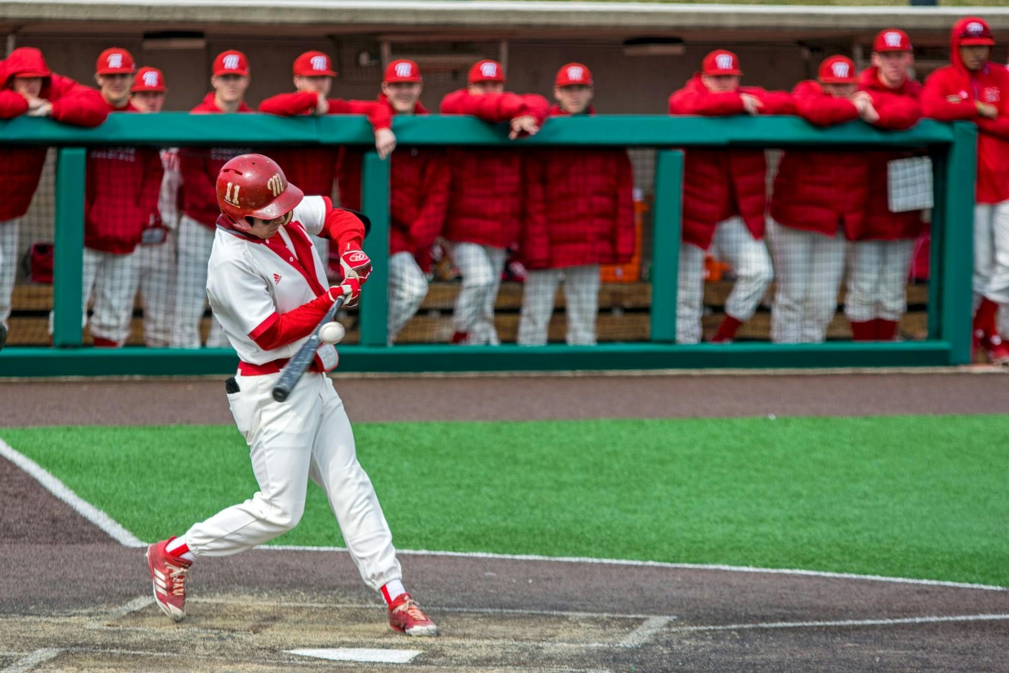 Cristian Tejada takes a hearty cut at a pitch, as his teammates look on from the dugout. Tejada finished the 2019 season with a .339/.453/.497 slash line and 26 runs batted in.