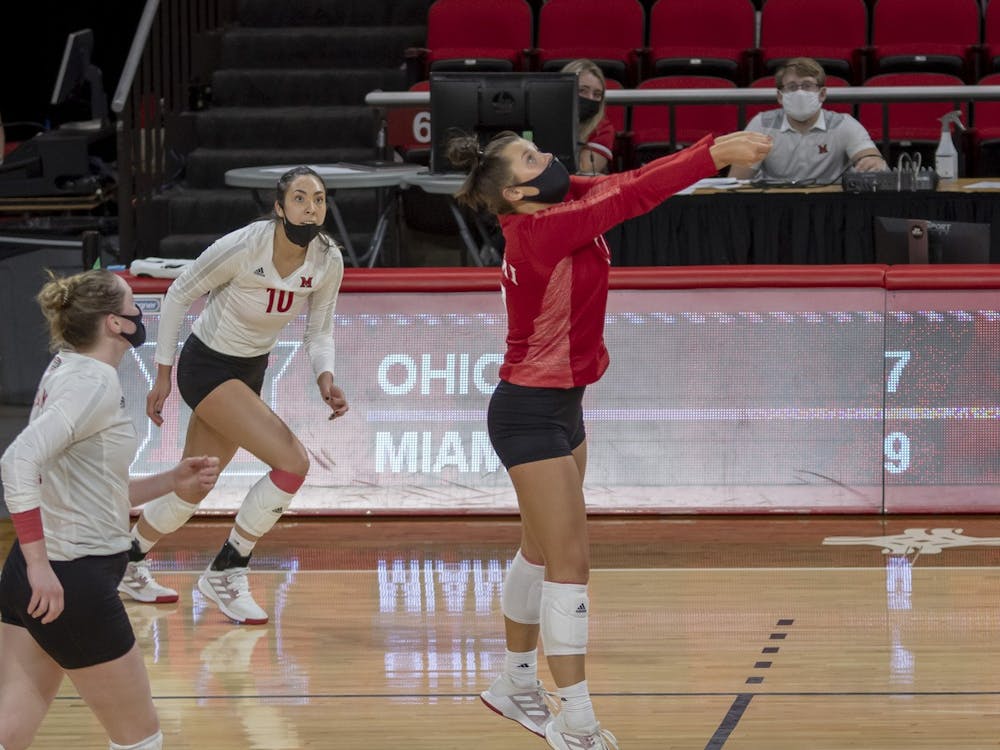 Senior libero Abigail Huser (pictured, in red) executes a bump during a week series vs. Ohio University.