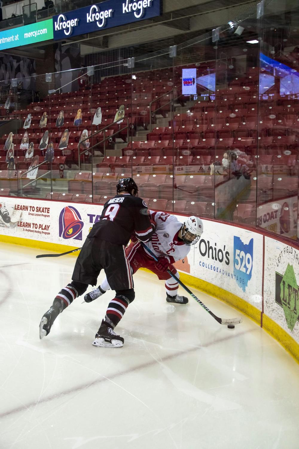Senior forward Phil Knies attempts to control the puck during a weekend series vs. St Cloud State.