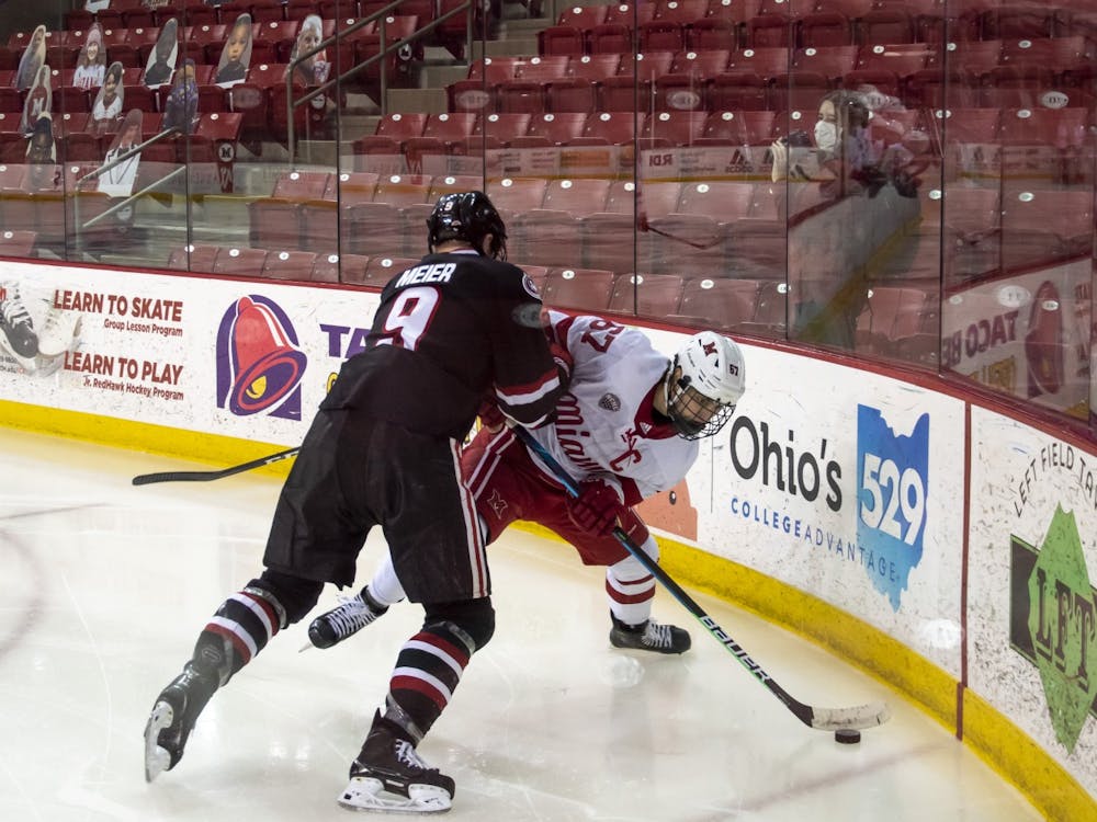 Senior forward Phil Knies attempts to control the puck during a weekend series vs. St Cloud State.