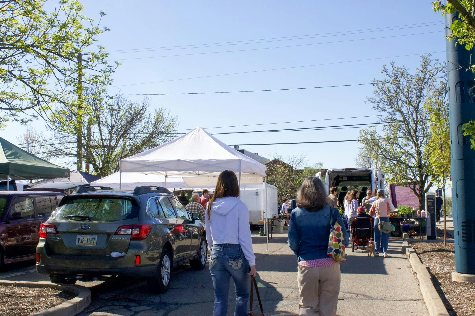 People walk into the Oxford Farmer’s market Saturday morning.