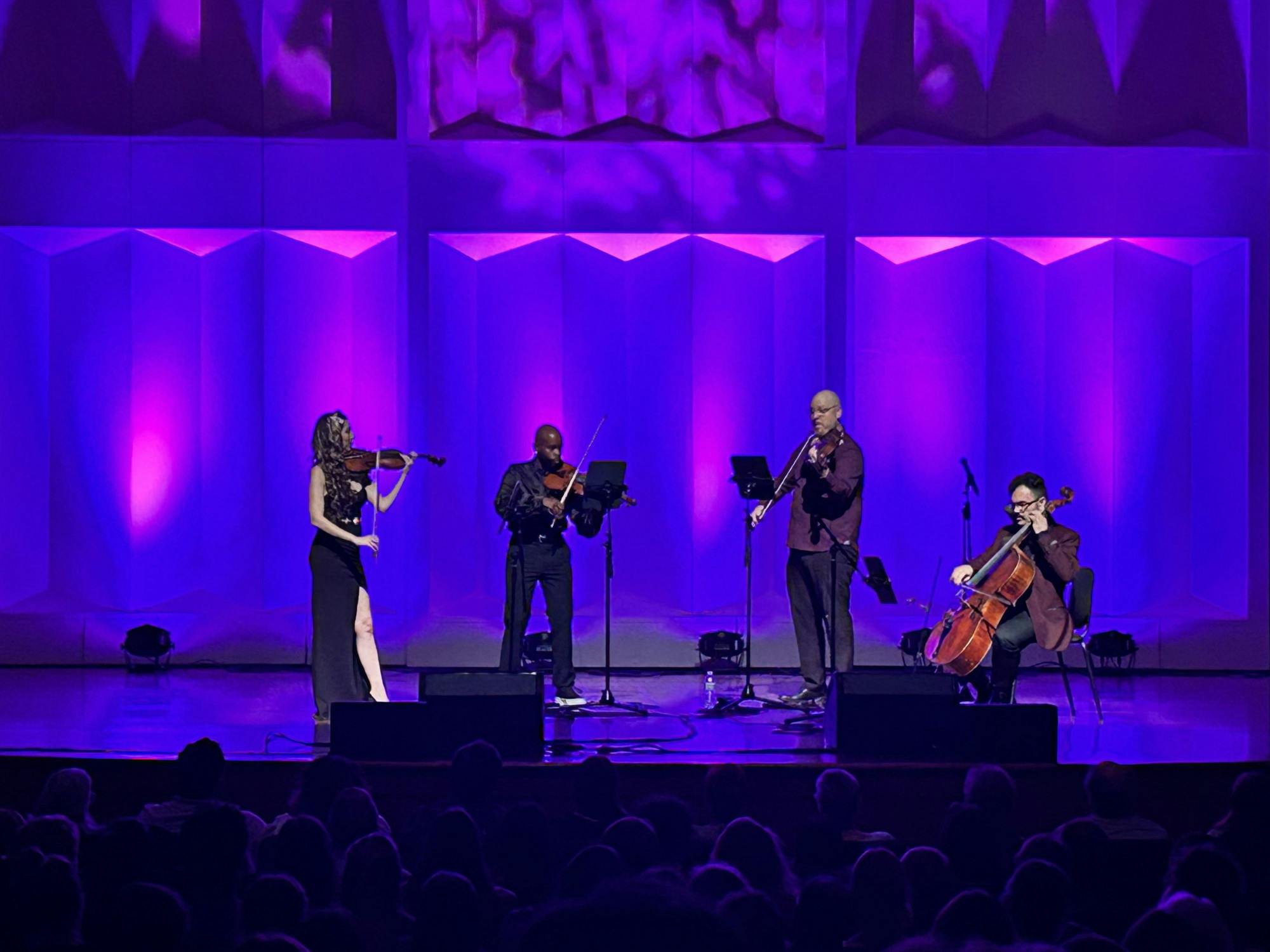 The Vitamin String Quartet, performing at Hall Auditorium on Tuesday, Oct. 24, played Prince's “Purple Rain” in front of a royal purple background.
