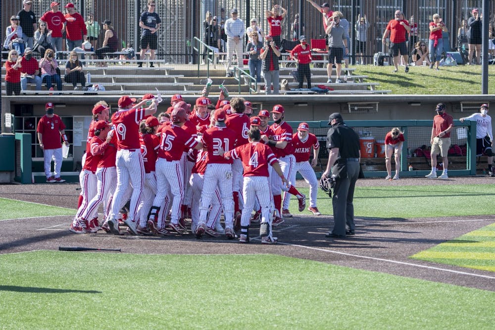 <p>The entire Miami bench mobs outfielder Nate Stone after his walk-off home run Saturday, Mar. 27, 2021.</p>