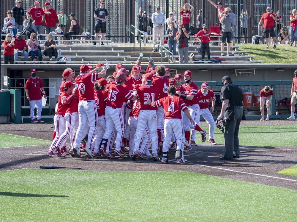 The entire Miami bench mobs outfielder Nate Stone after his walk-off home run Saturday.