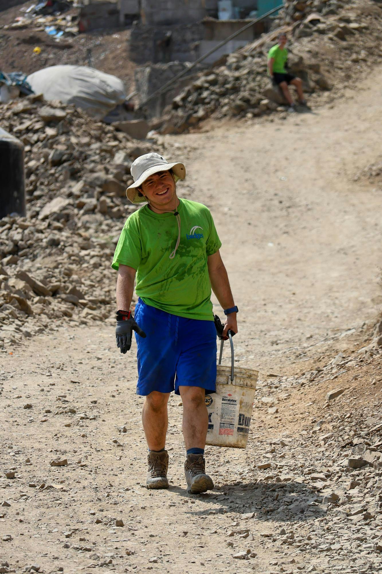 Gavin McGonagle carrying a bucket of water for concrete mix. Photo provided by Gavin McGonagle