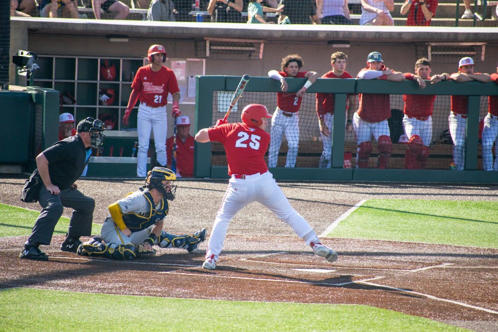 Junior Tommy Harrison steps into his swing during game against Michigan on April 21.
