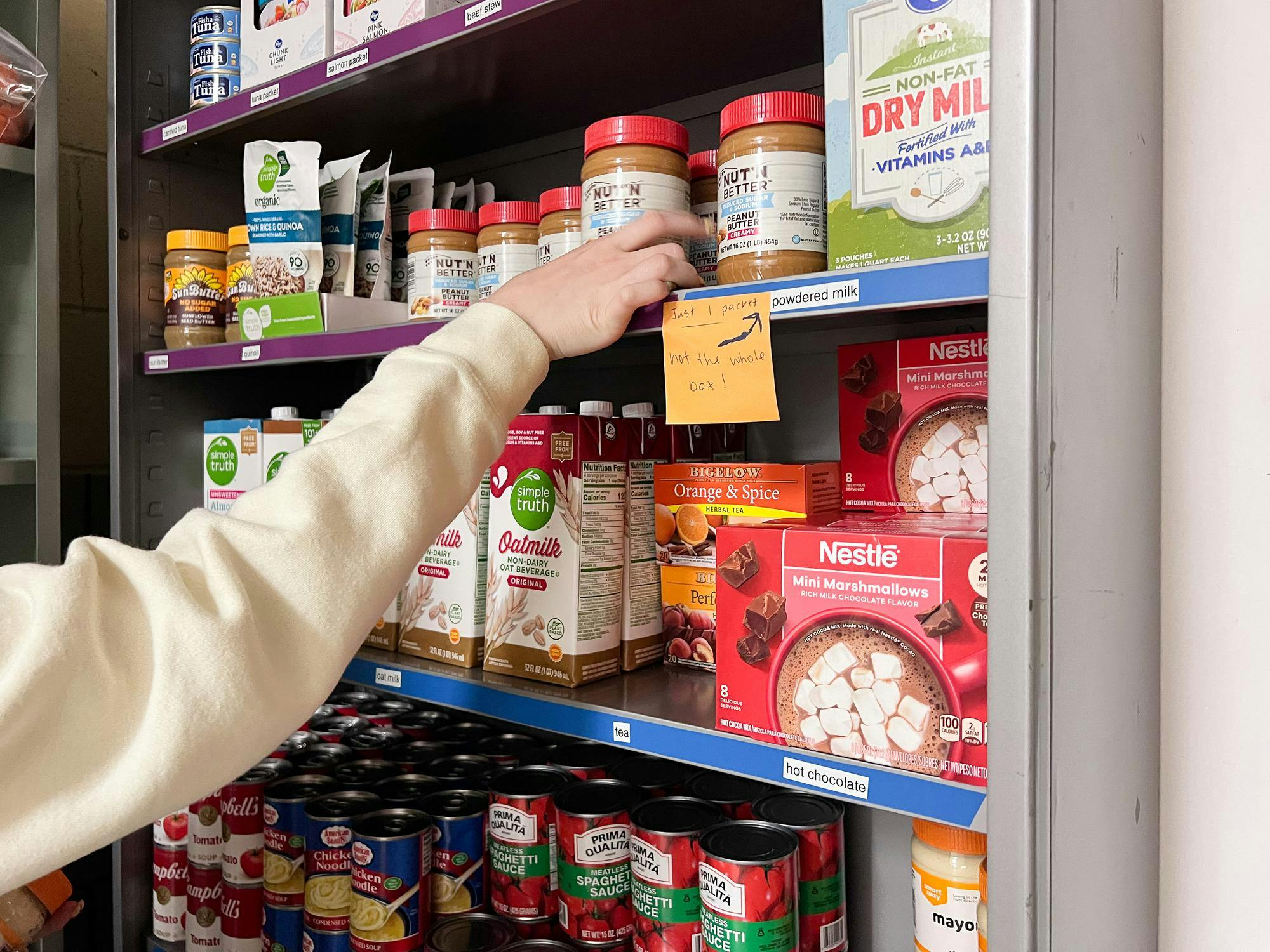 Reagan Morrow organizes food in the Phillips Hall food pantry.