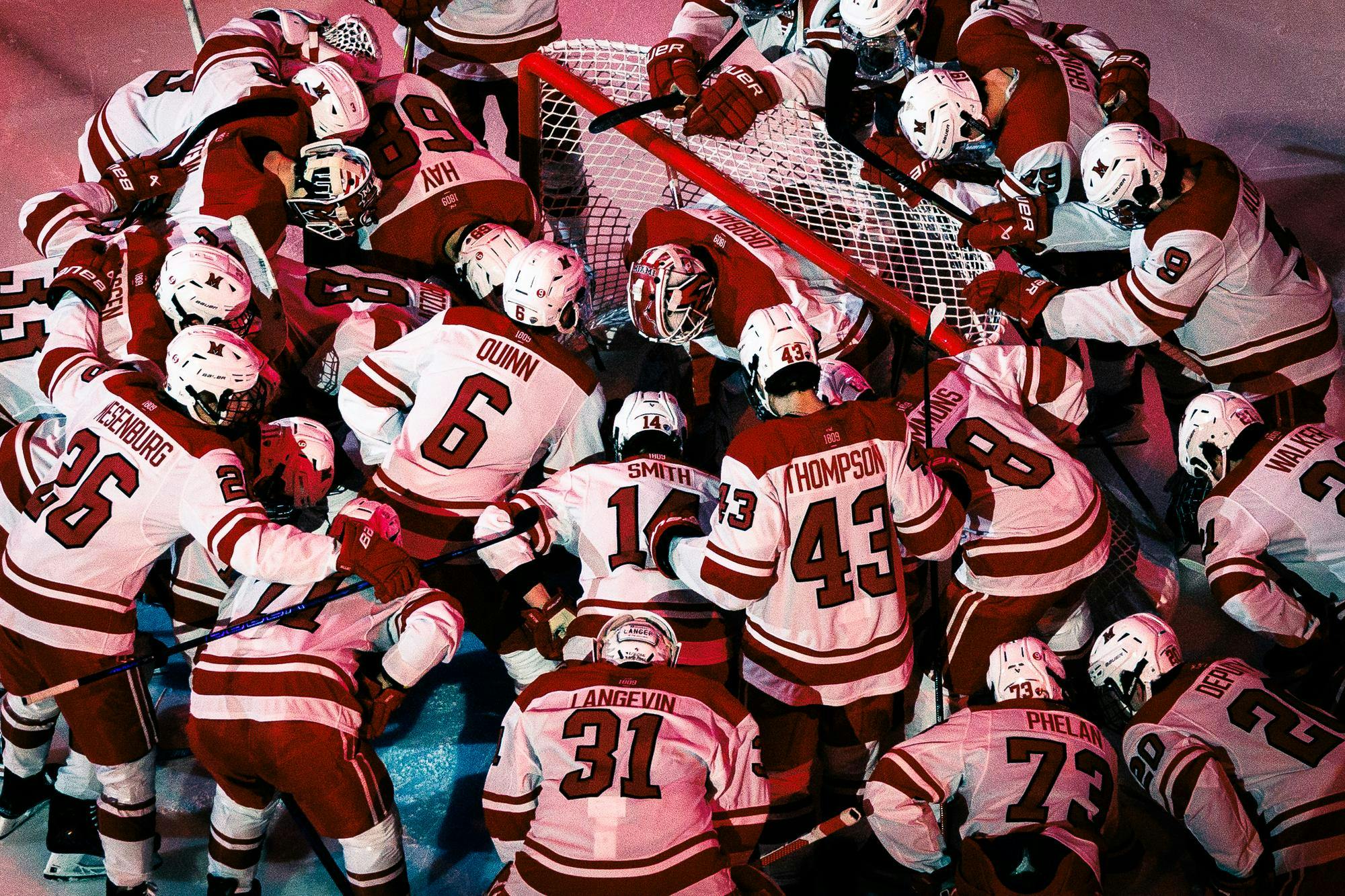 The Miami hockey team gathers at the home net against the University of Minnesota-Duluth at Goggin Ice Center on Feb. 21