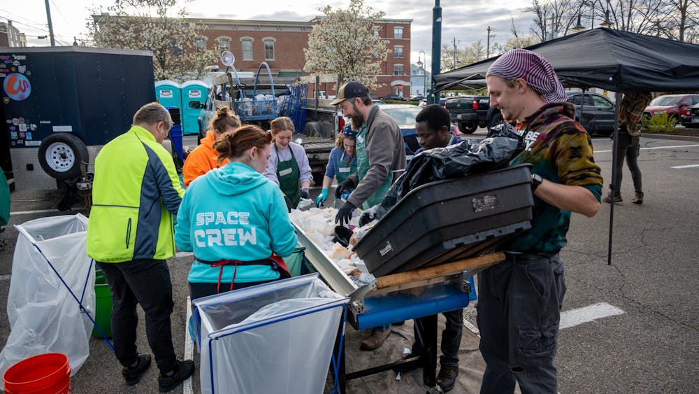 Volunteers stand around a conveyor belt at the April Solar Eclipse event and sort waste by hand into the correct bins. Photo provided by Reena Murphy