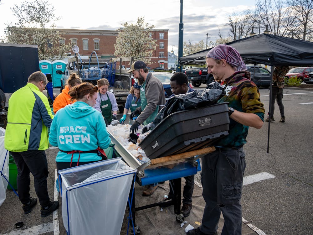 Volunteers stand around a conveyor belt at the April Solar Eclipse event and sort waste by hand into the correct bins. Photo provided by Reena Murphy