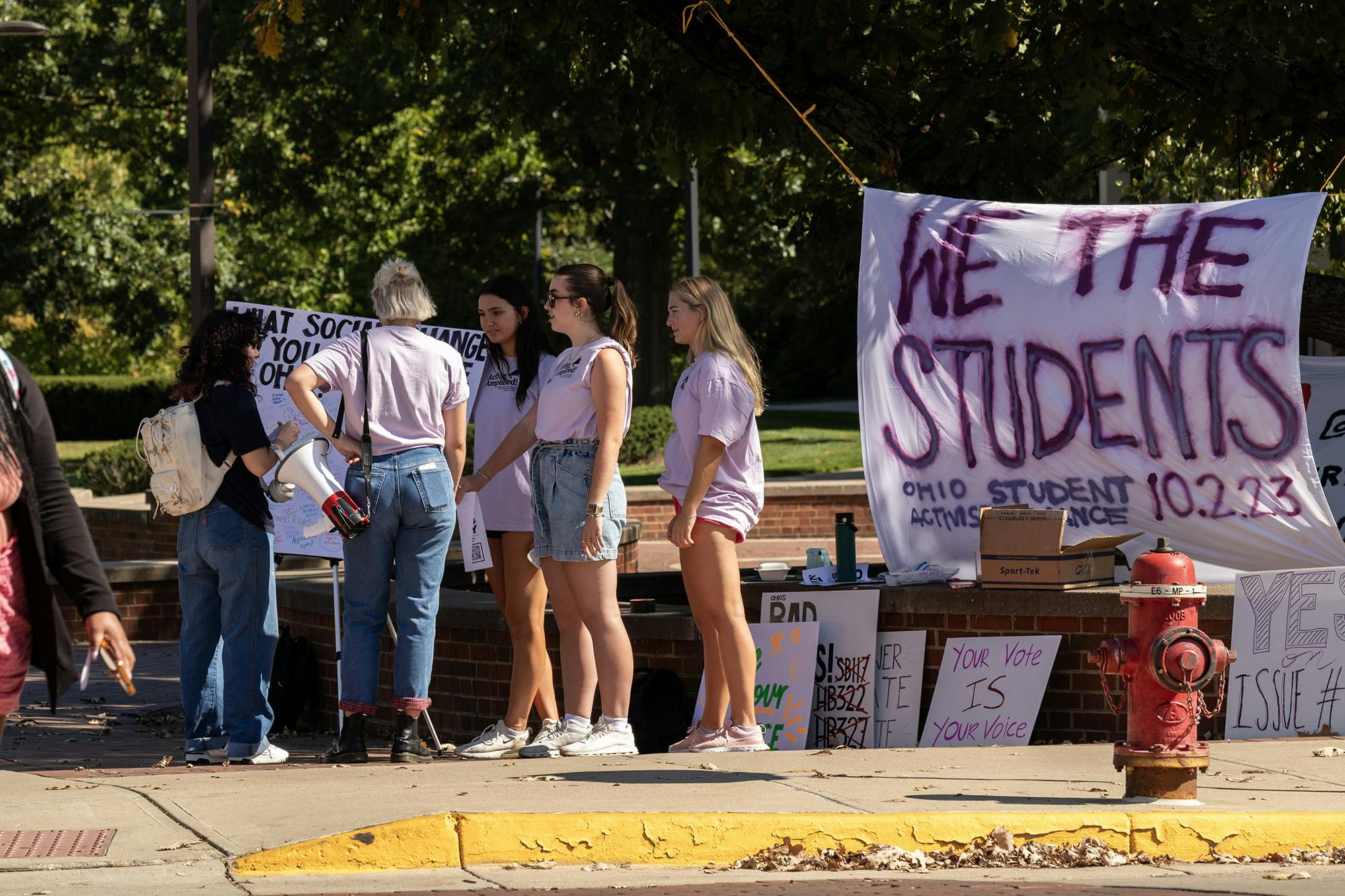Olivia Gallo and Clara Conover, who led OSAA&#x27;s Day of Action,﻿ stood at the corner outside Shriver to vocalize student activism.
